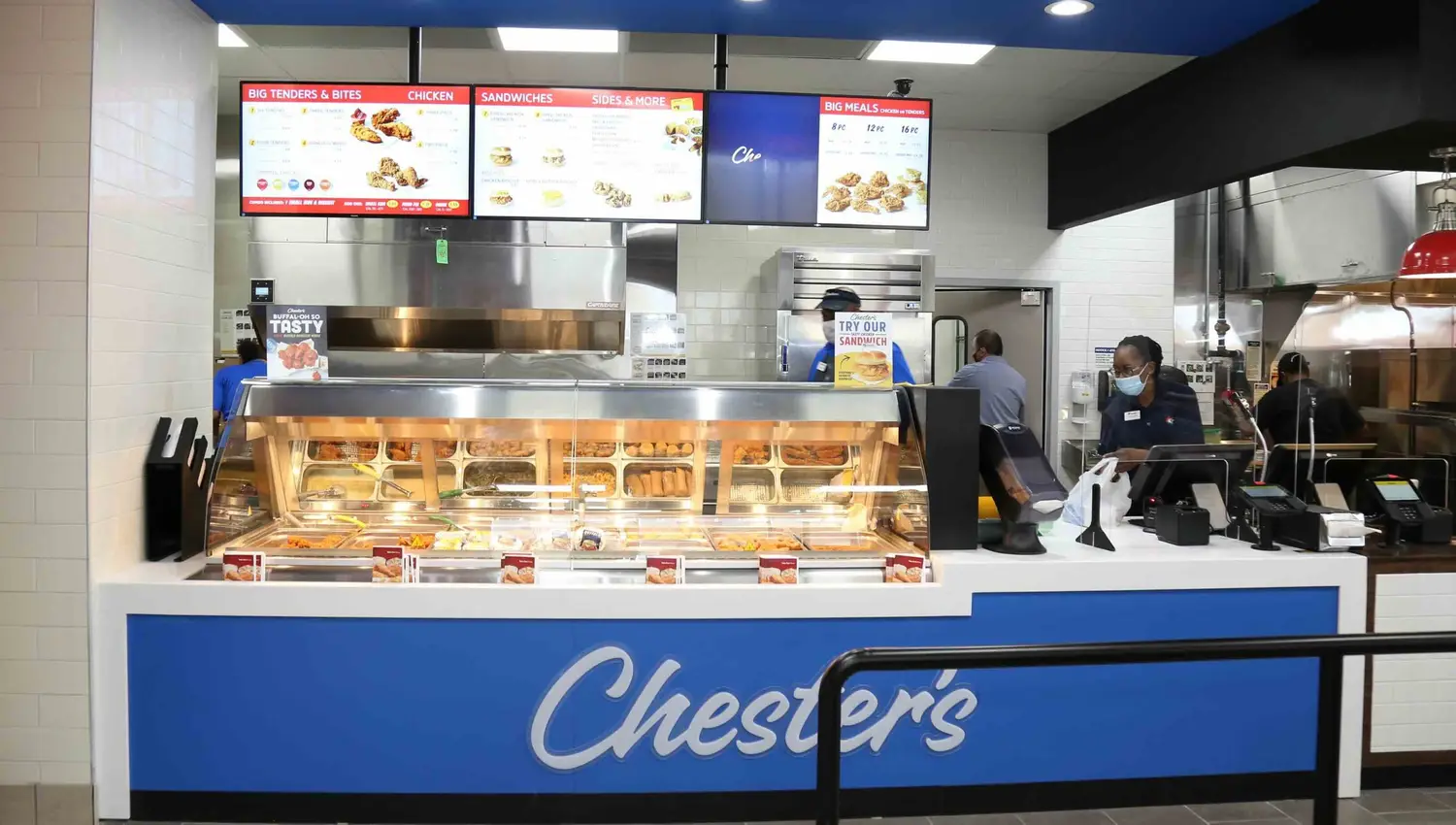 Fast food counter with menu displays.