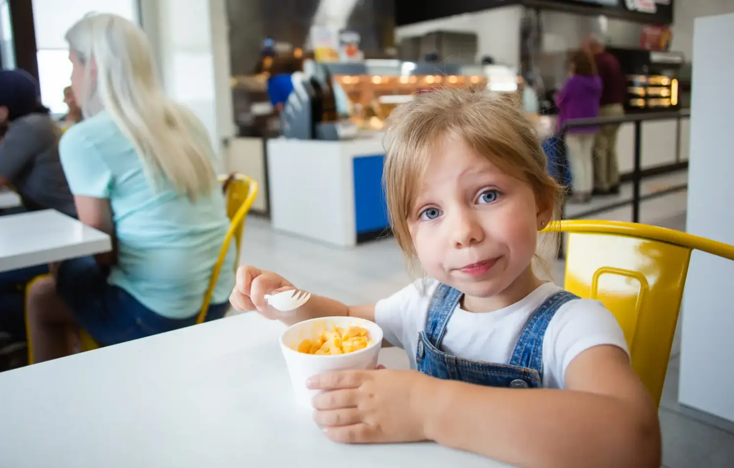 little girl eating mac and cheese